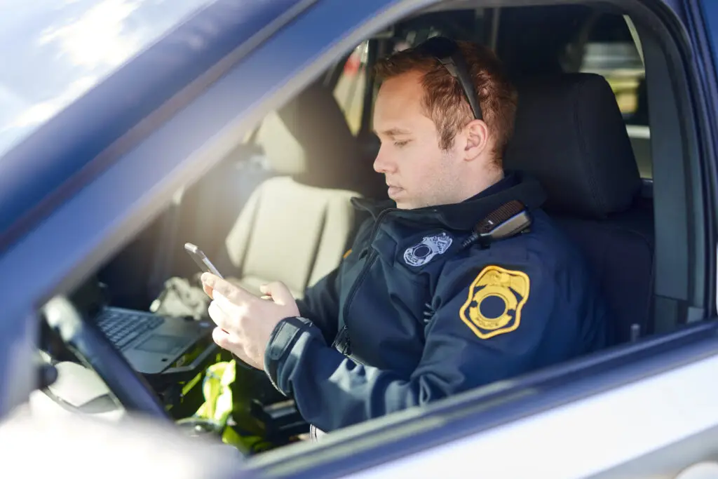 Policeman in cruiser